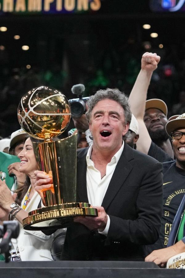 Wyc Grousbeck holds the championship trophy after the Celtics win the title.