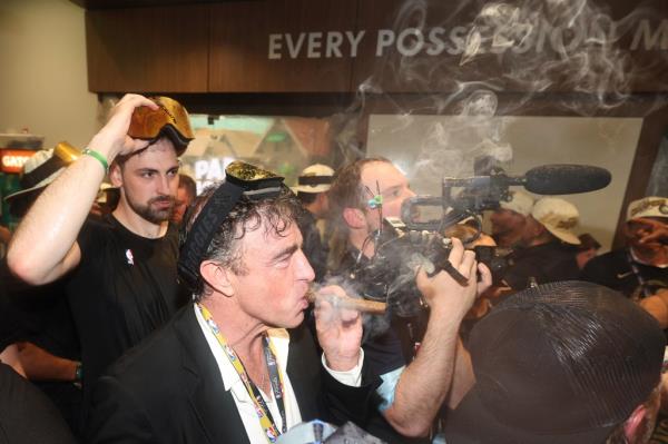 Wyc Grousbeck smoking a victory cigar after the Celtics win the title.